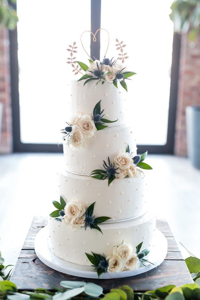 Emily & Daring Wedding - Wedding Cake spray roses and blue thistle - Battello NJ - Photography by Casey Fatchett