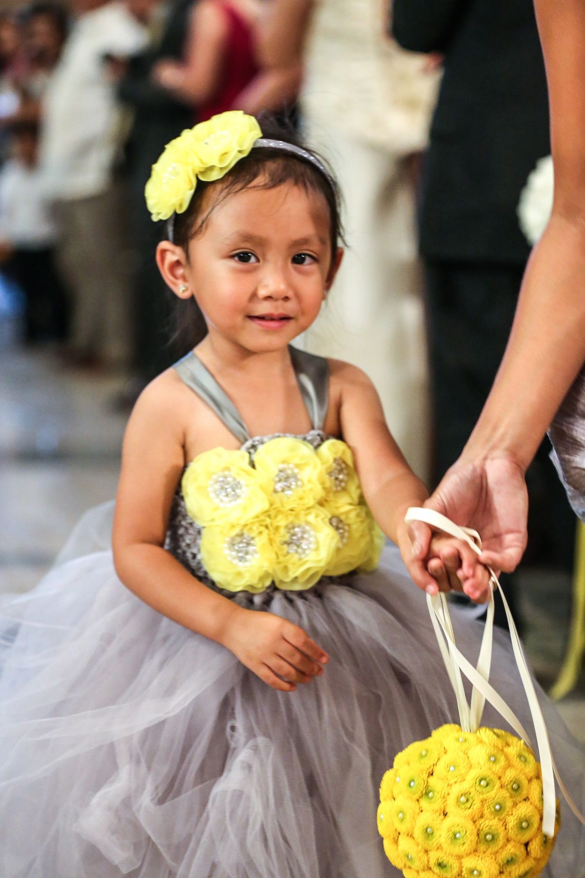 Flower girl carried bouquet of bright yellow mums with pearls at their centers.