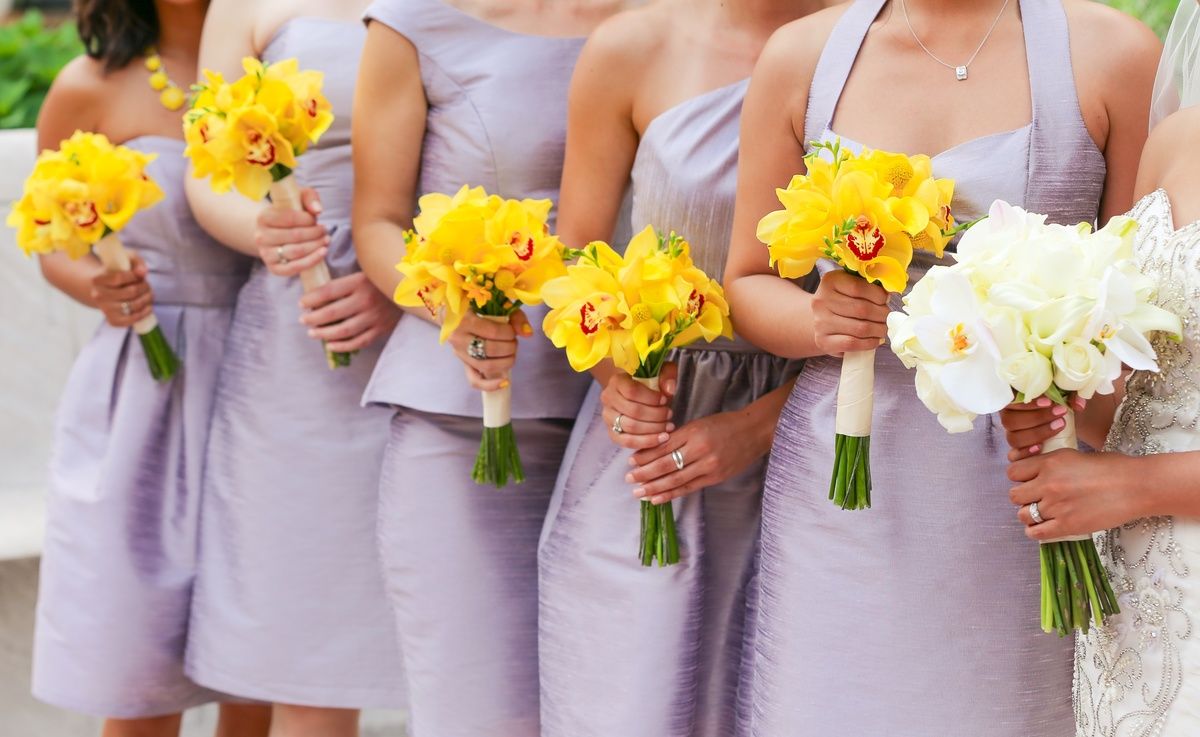 Bridesmaids with bouquets of yellow cymbidium orchids