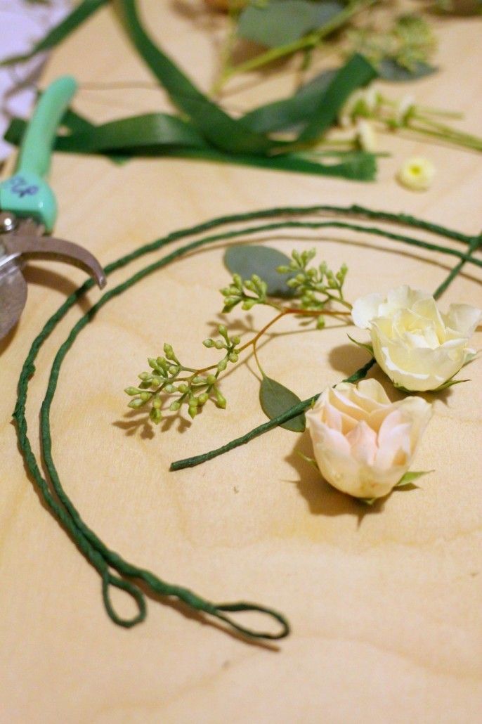 Begin by twisting several lengths of floral wire into a headband shape. Form loops at each end.