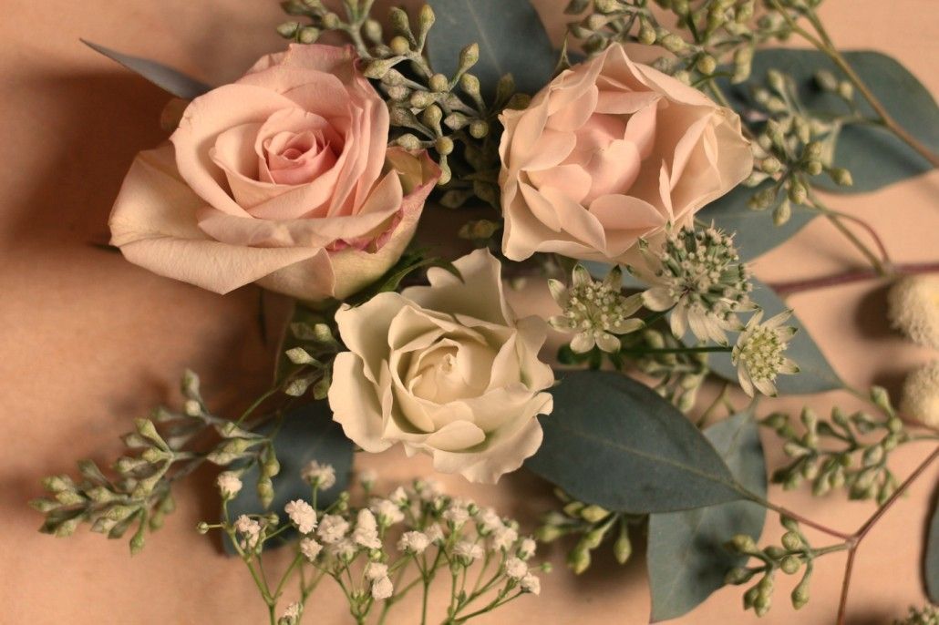 Prepare flowers and greenery by trimming stems, then think about composition and color variation. Cool-toned seeded eucalyptus complimented pale pinks and whites.