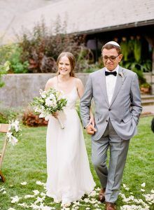 Emma and Izzet Wedding - Bride Walking Down Aisle with Dad Bridal Bouquet of Casablanca Lily Olive Greens Dendro Orchid Pitt Ruscus and Stock - Blue Hill at Stone Barns NY - By Rebecca Yale - 099